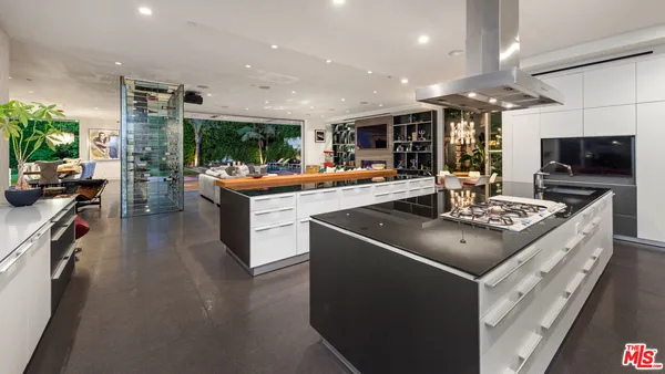 a bathroom with a sink a large mirror and a shower