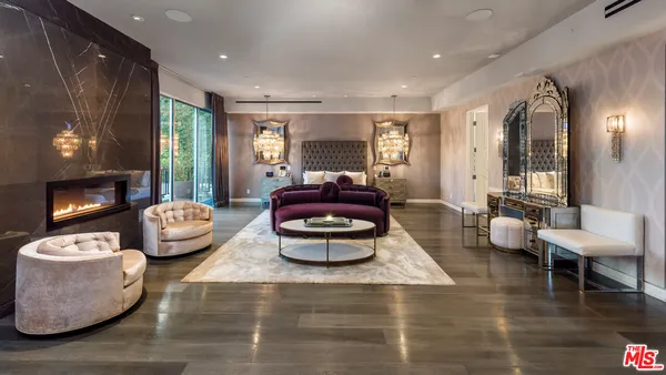 a living room with patio furniture and a floor to ceiling window
