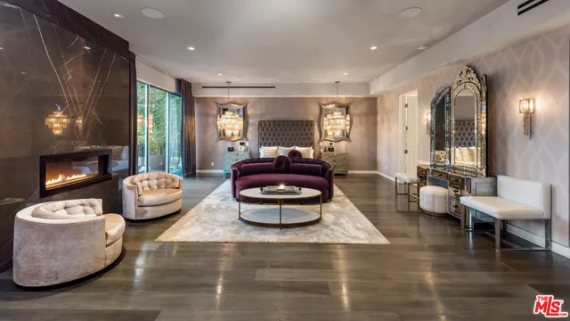 a living room with patio furniture and a floor to ceiling window