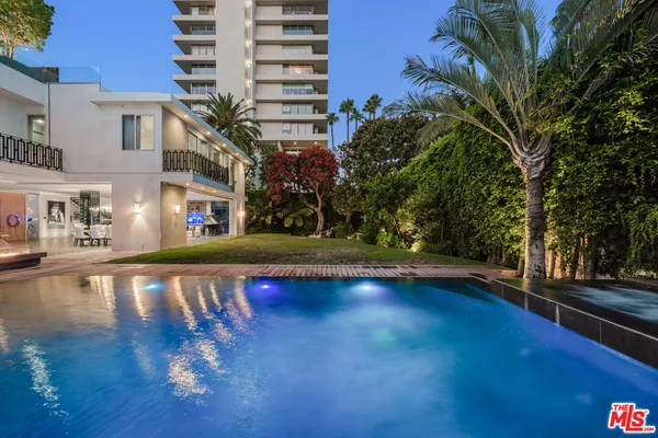 a front view of a building with play ground and outdoor seating