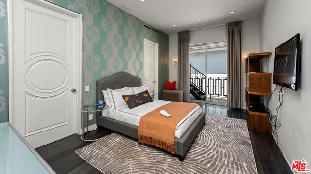 an aerial view of a house with a garden and outdoor seating