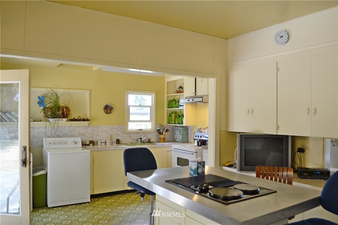 5791 Double Bluff Road Freeland, WA 98249 - Photo 12 of 25 a kitchen with a stove a sink and a refrigerator