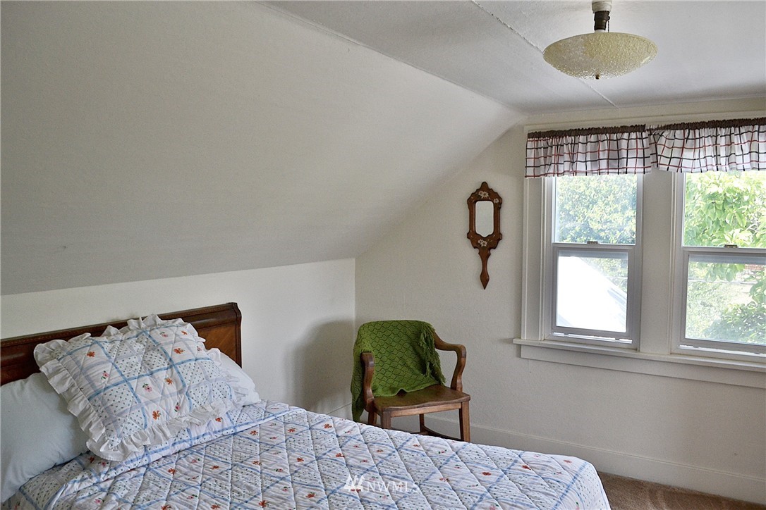 5791 Double Bluff Road Freeland, WA 98249 - Photo 13 of 25 a bedroom with a bed and a window