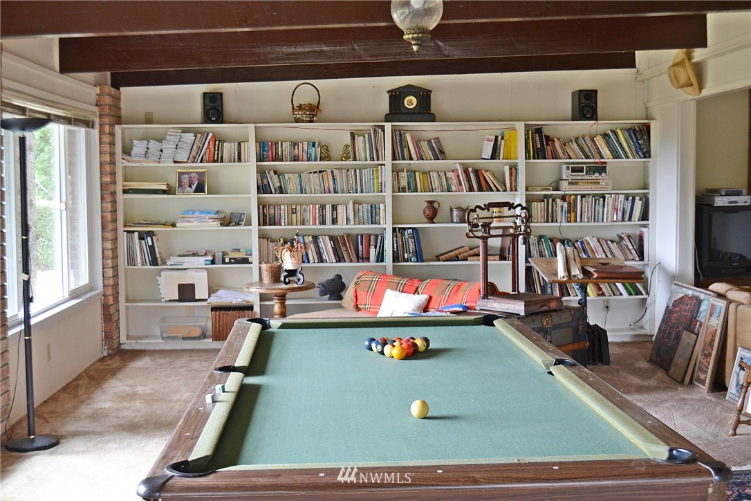 5791 Double Bluff Road Freeland, WA 98249 - Photo 15 of 25 a room with furniture and a book shelf