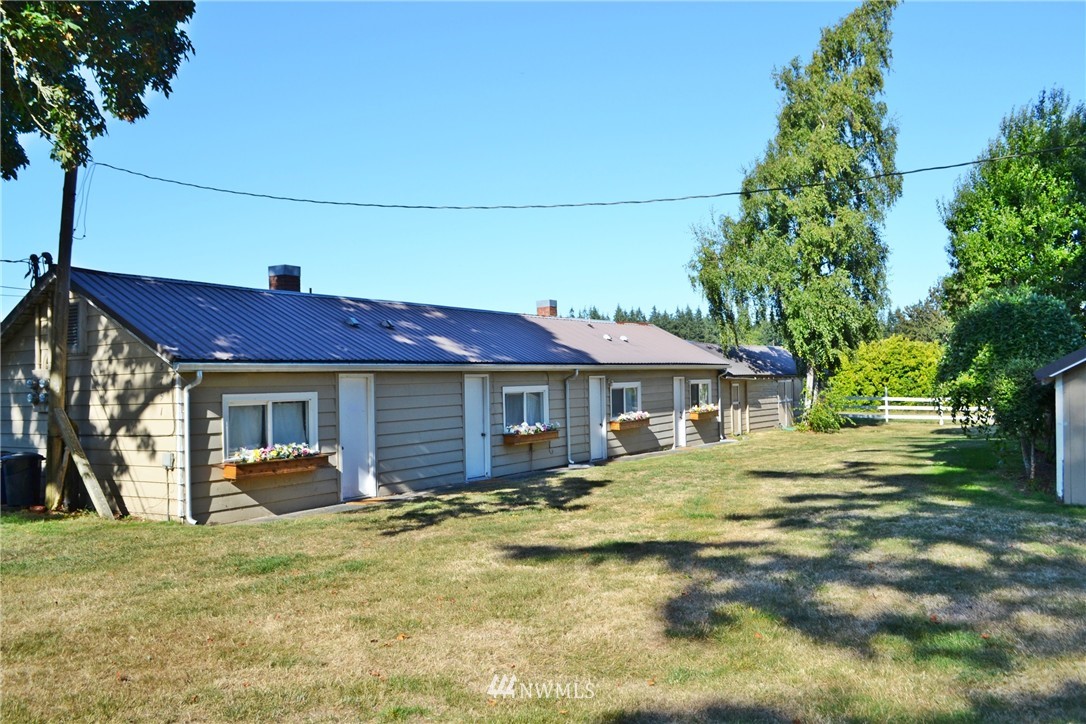 5791 Double Bluff Road Freeland, WA 98249 - Photo 22 of 25 a front view of a house with a yard and garage