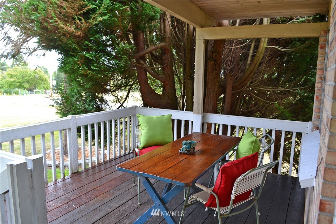 5791 Double Bluff Road Freeland, WA 98249 - Photo 4 of 25 a view of a balcony with wooden floor and outdoor seating