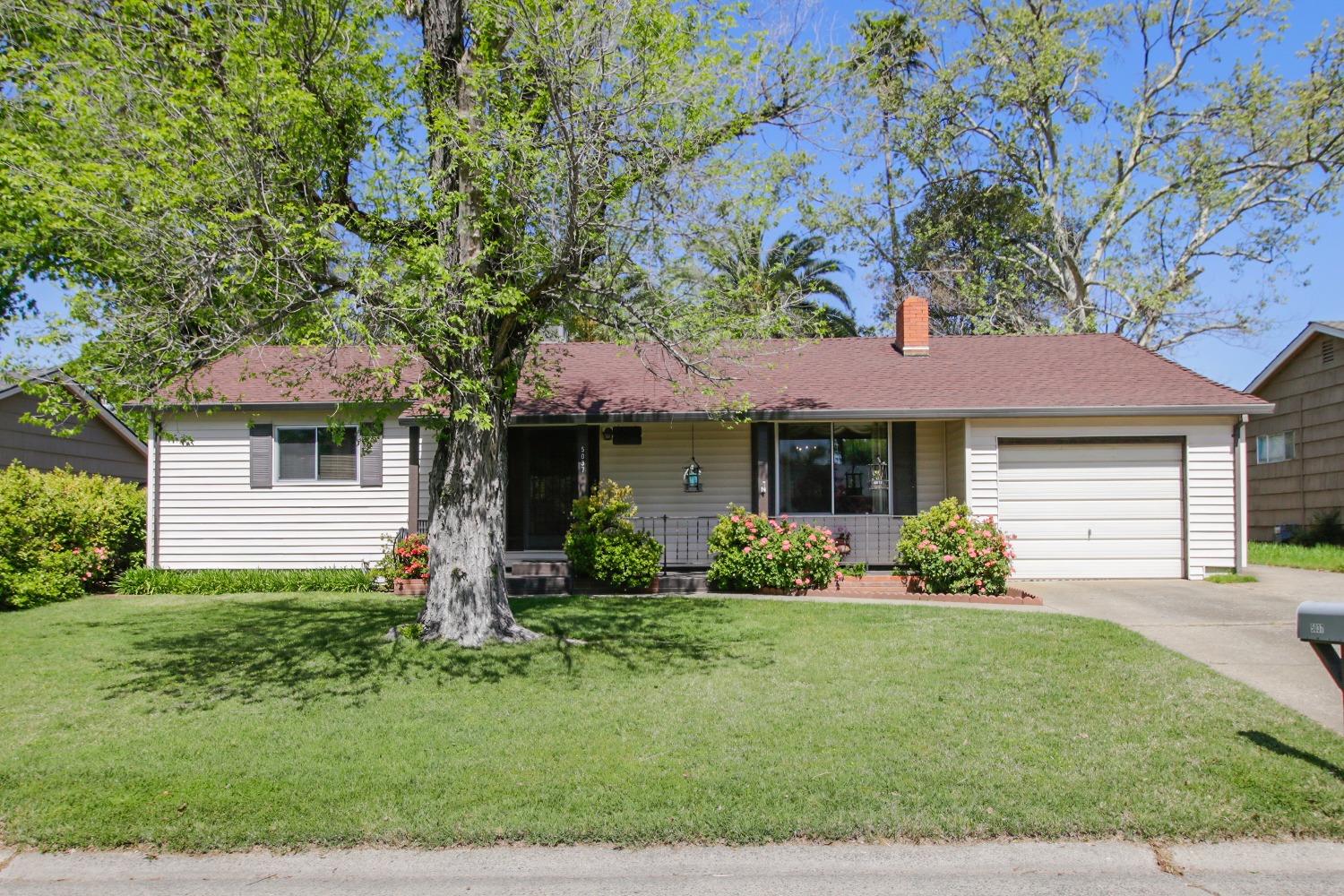 a front view of a house with a yard and porch