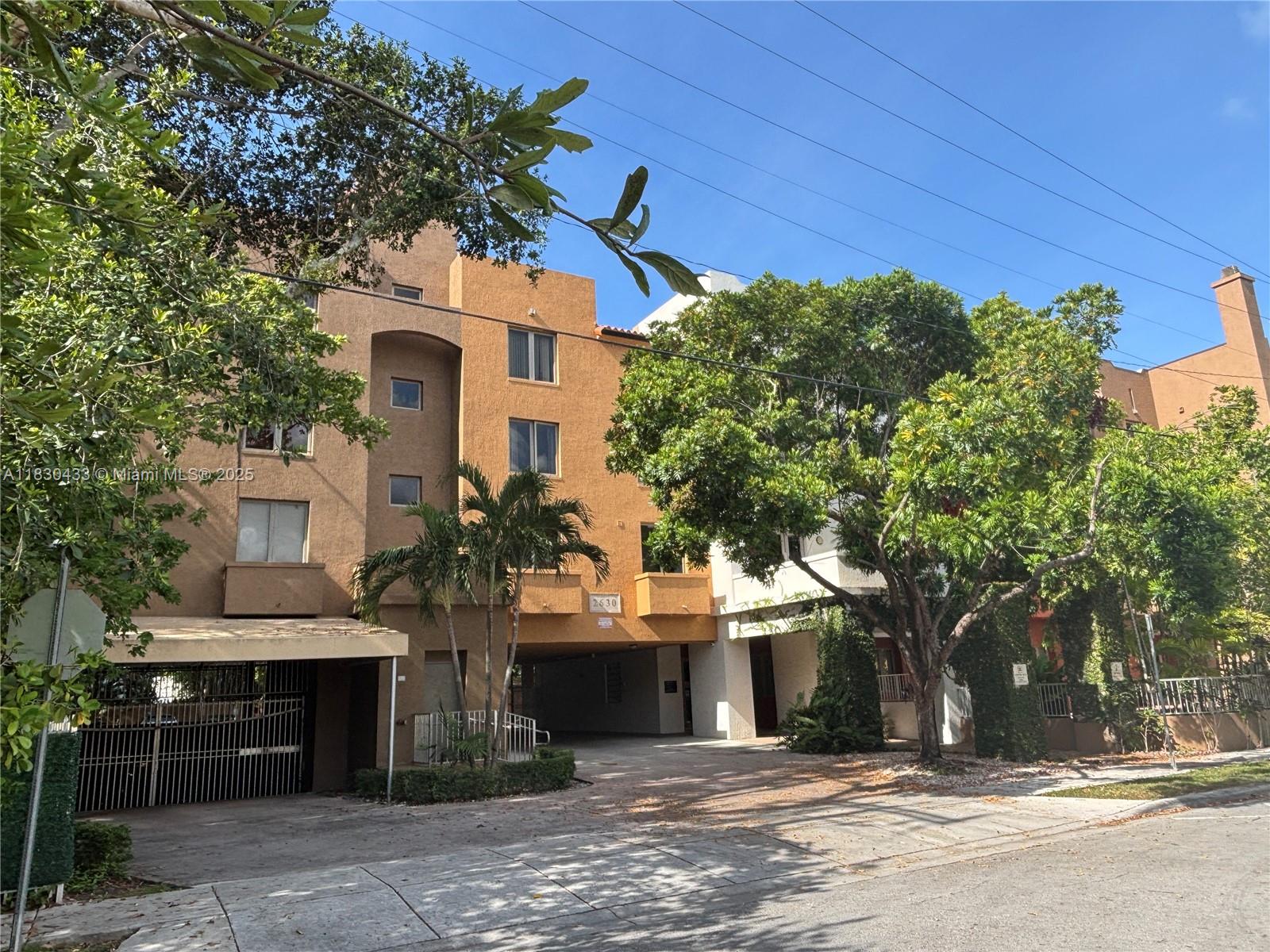 2630 Southwest 28th Street, Unit 34 Miami, FL 33133 - Photo 1 of 26 a front view of a house with a yard