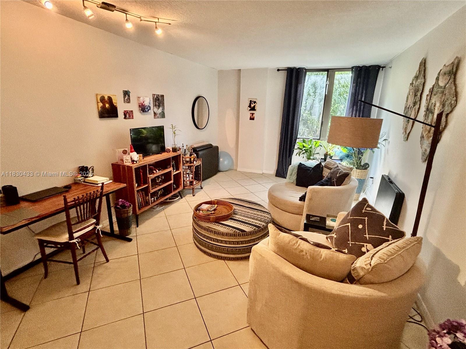 2630 Southwest 28th Street, Unit 34 Miami, FL 33133 - Photo 12 of 26 a living room with furniture and a large window