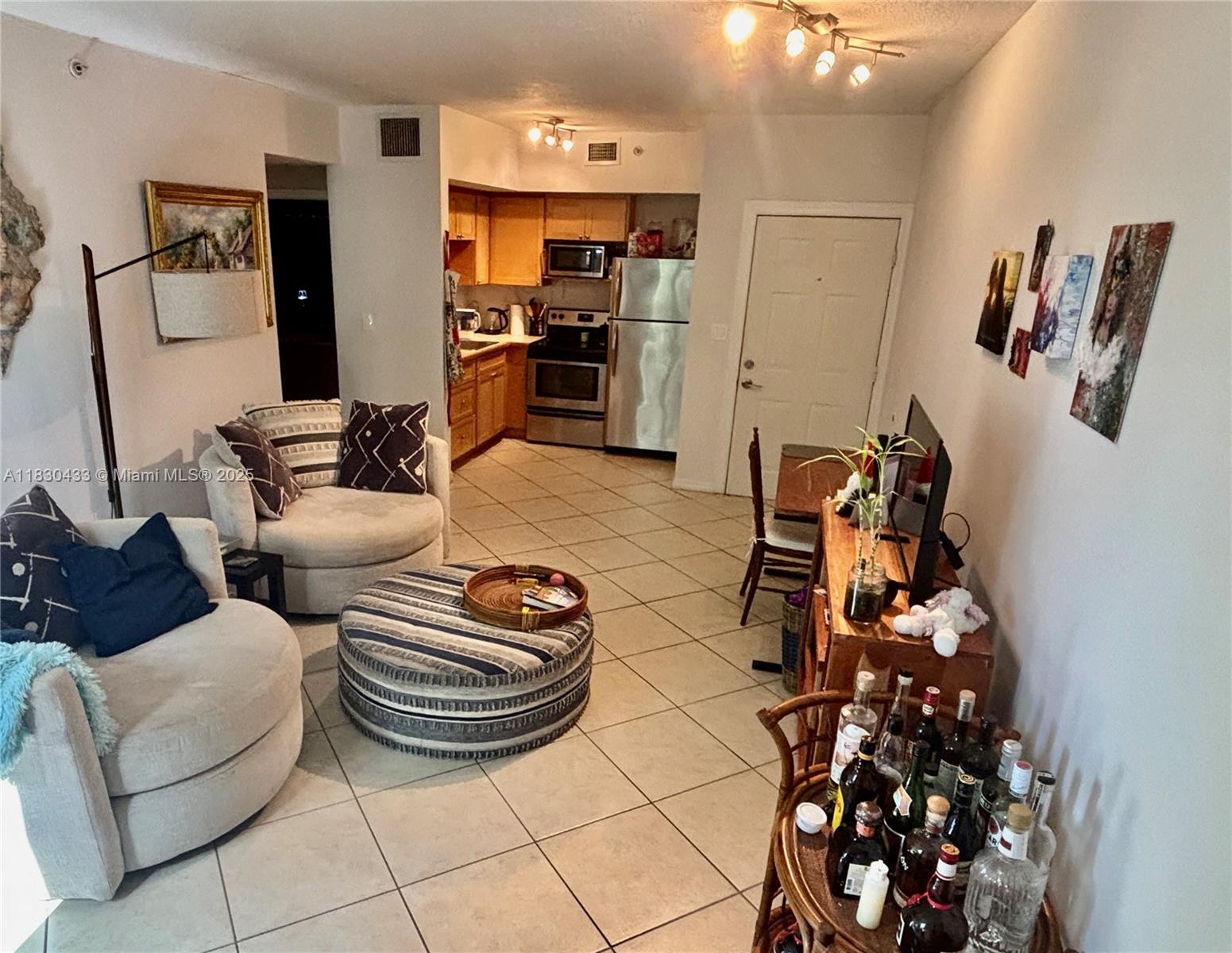 2630 Southwest 28th Street, Unit 34 Miami, FL 33133 - Photo 13 of 26 a living room with furniture and a flat screen tv