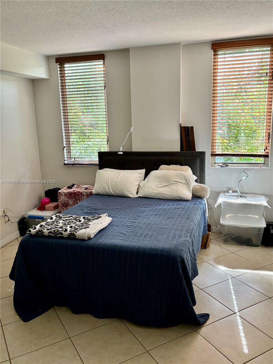 2630 Southwest 28th Street, Unit 34 Miami, FL 33133 - Photo 15 of 26 a bedroom with a bed and window