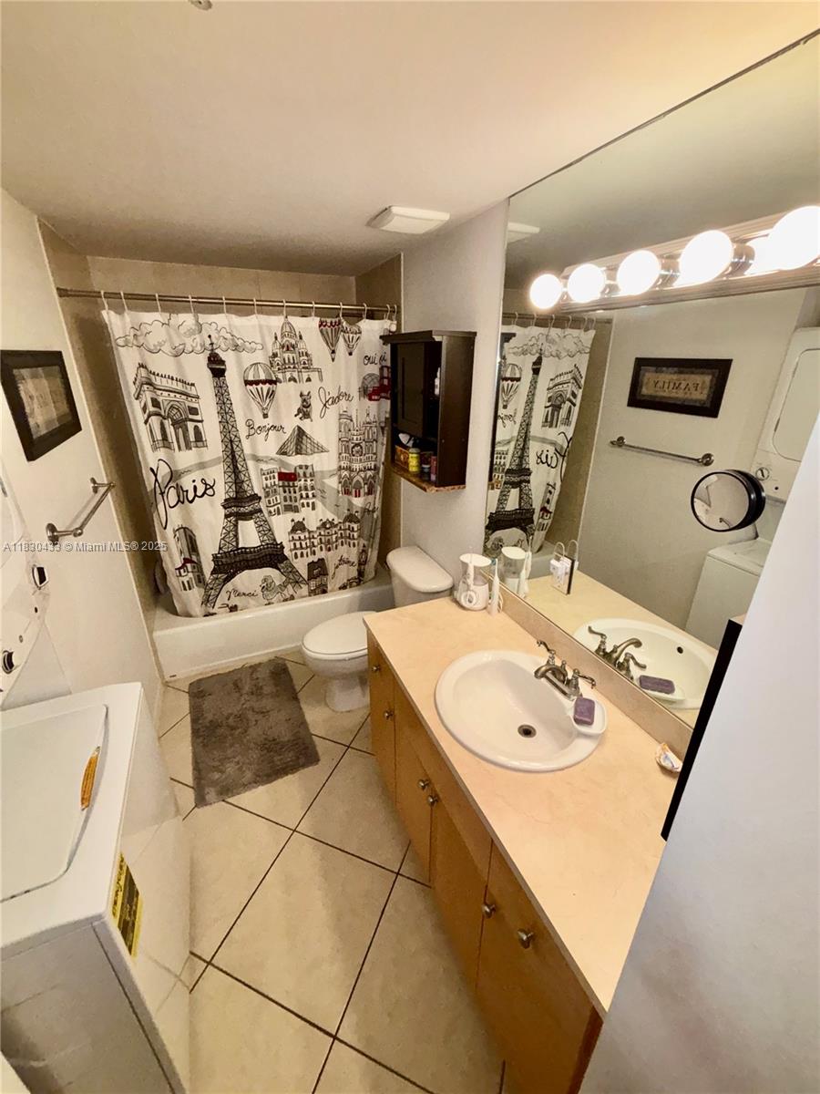 2630 Southwest 28th Street, Unit 34 Miami, FL 33133 - Photo 19 of 26 a bathroom with a sink mirror and shower