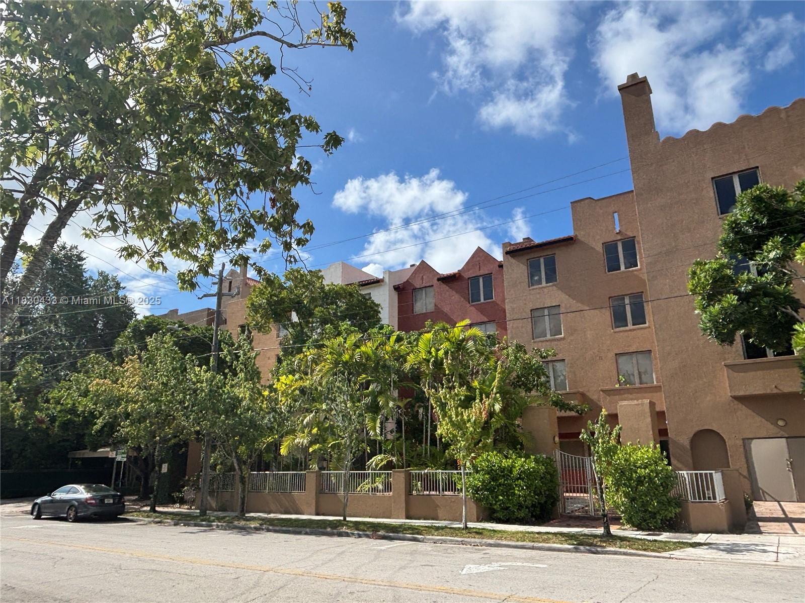 2630 Southwest 28th Street, Unit 34 Miami, FL 33133 - Photo 2 of 26 a front view of a house with a yard and tree s