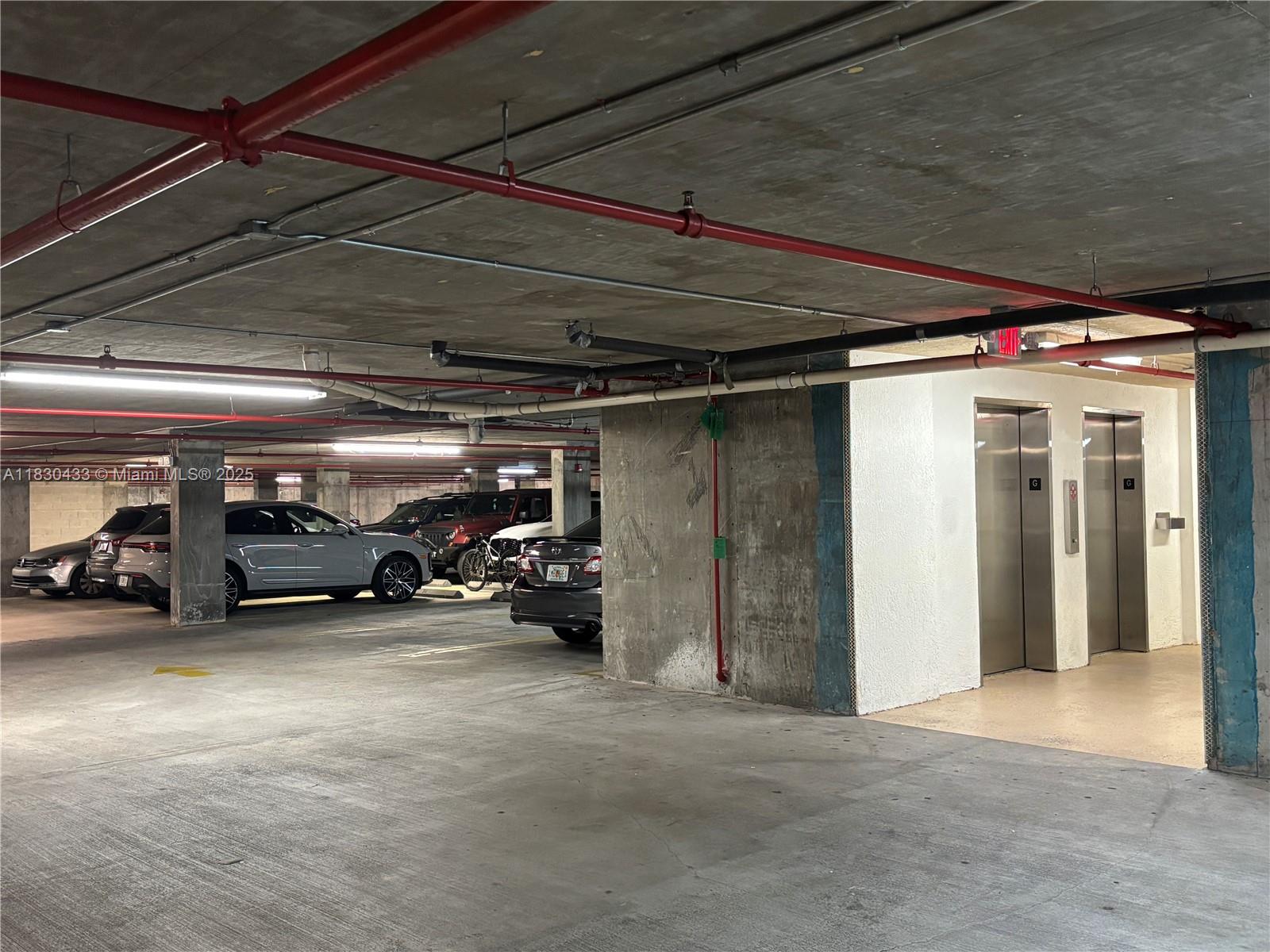 2630 Southwest 28th Street, Unit 34 Miami, FL 33133 - Photo 22 of 26 a view of parking garage with cars