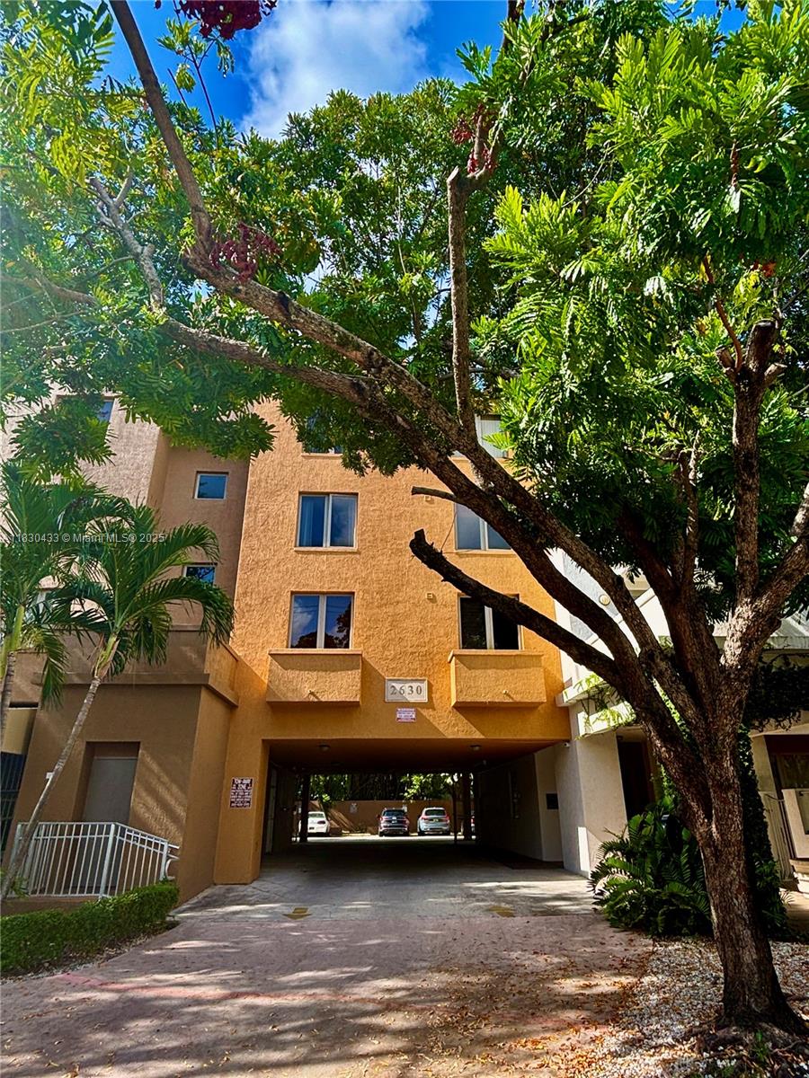 2630 Southwest 28th Street, Unit 34 Miami, FL 33133 - Photo 3 of 26 a front view of a house with a yard