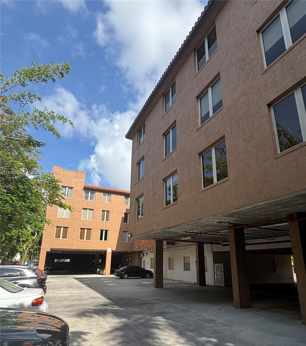 2630 Southwest 28th Street, Unit 34 Miami, FL 33133 - Photo 4 of 26 a front view of a house with a yard