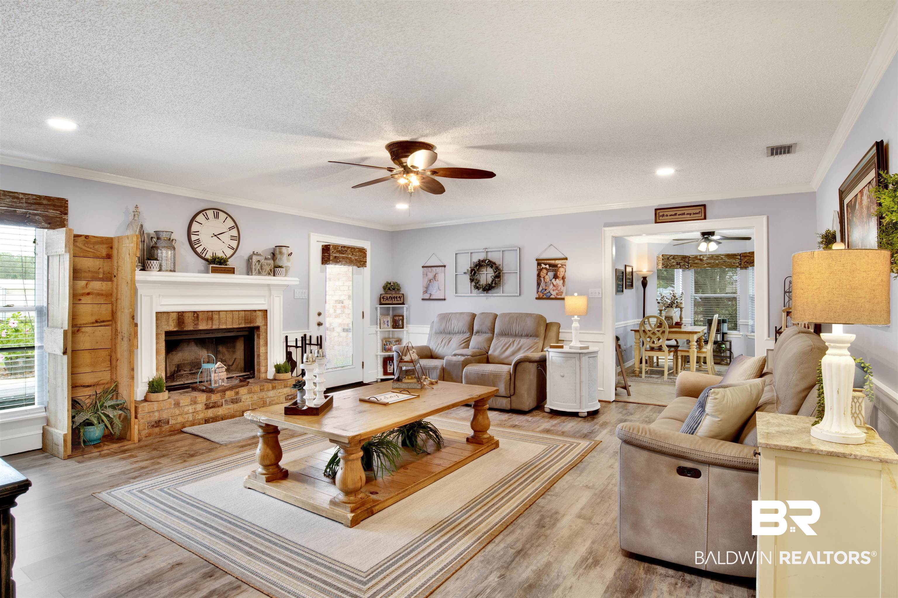 13385 Tom Gaston Road Mobile, AL 36695 - Photo 8 of 42 Living room with a textured ceiling, light wood-type flooring, ceiling fan, and a brick fireplace