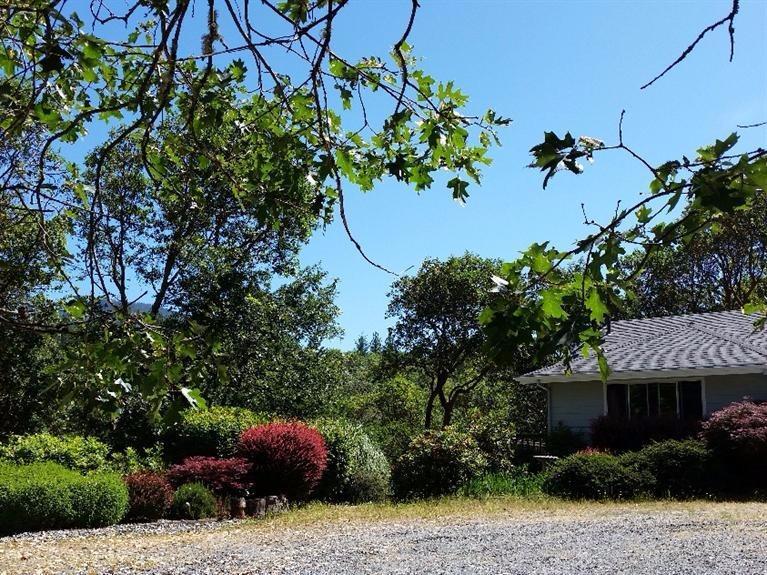 1111 Three Pines Road Grants Pass, OR 97526 - Photo 2 of 28 LANDSCAPING TO LEFT OF HOUSE INCLUDING J