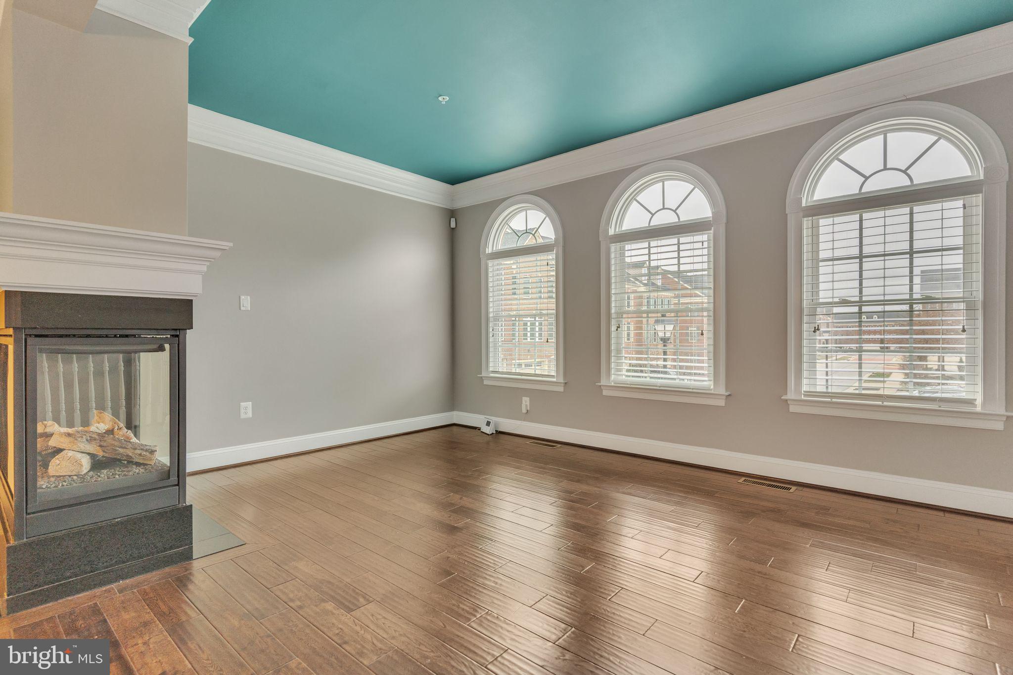 4927 Collingtons Bounty Drive Bowie, MD 20720 - Photo 14 of 38 a view of an empty room with wooden floor and a window