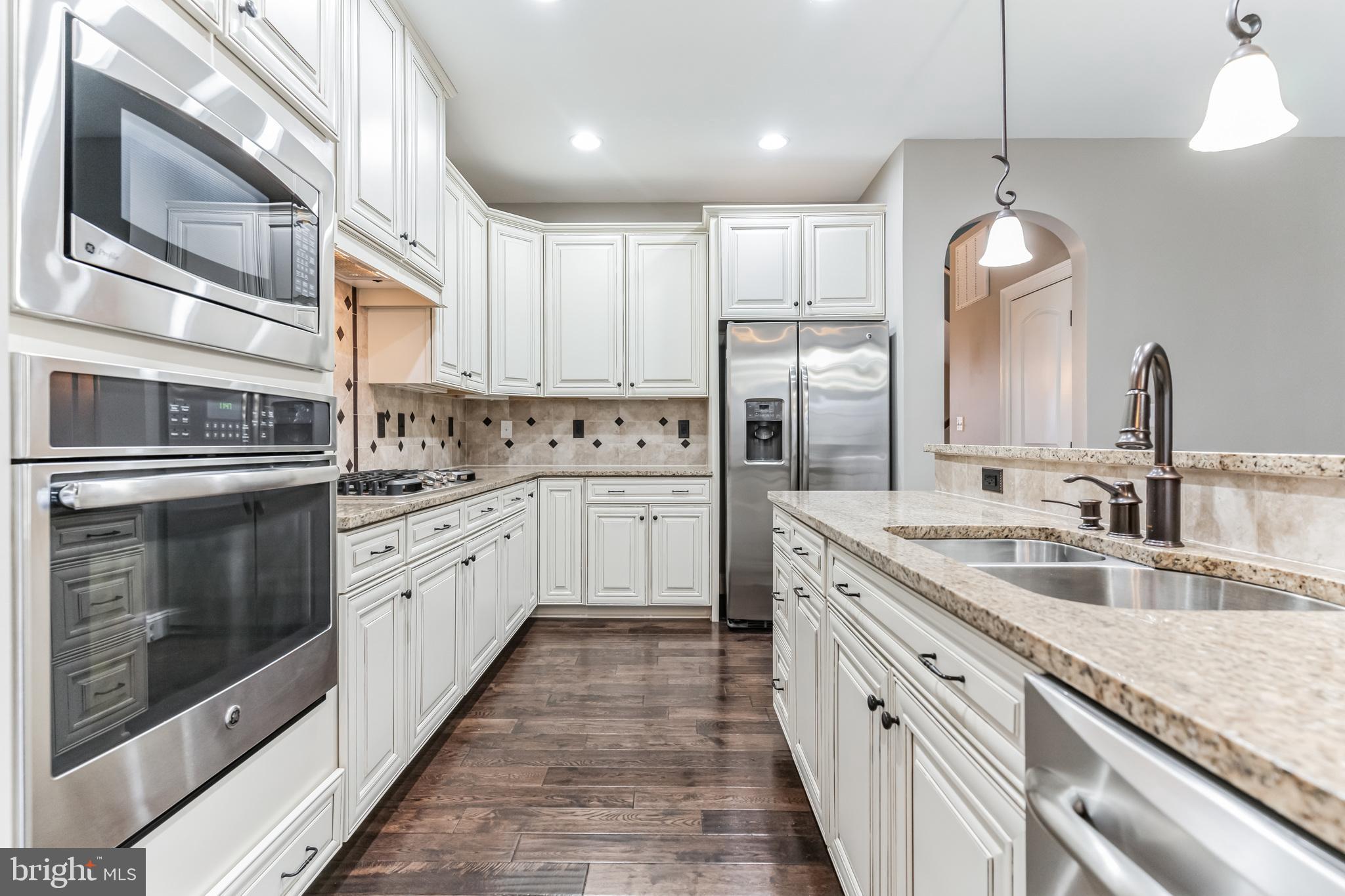 4927 Collingtons Bounty Drive Bowie, MD 20720 - Photo 2 of 38 a kitchen with stainless steel appliances granite countertop a sink a stove and a refrigerator