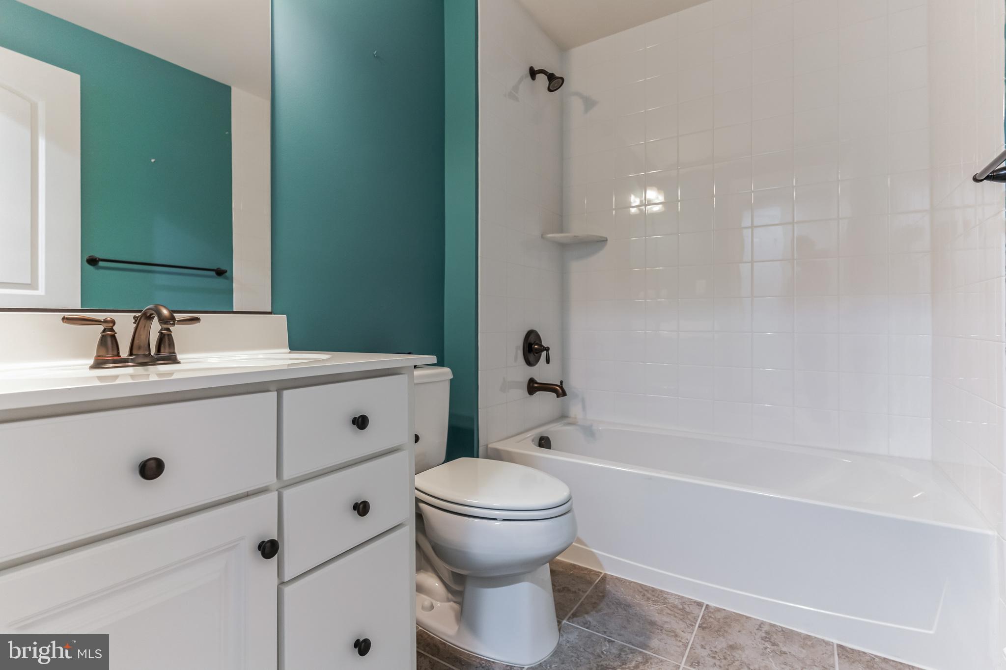 4927 Collingtons Bounty Drive Bowie, MD 20720 - Photo 26 of 38 a bathroom with a sink a toilet and a mirror