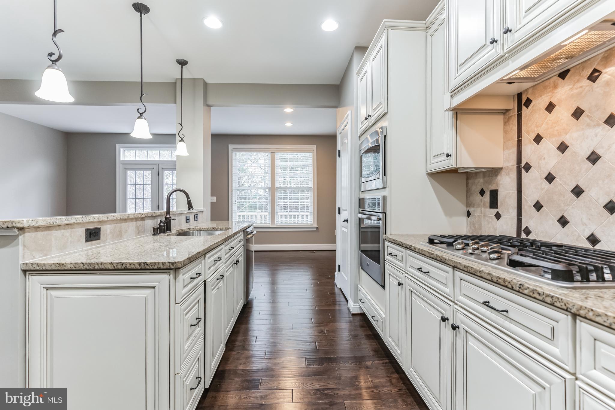 4927 Collingtons Bounty Drive Bowie, MD 20720 - Photo 3 of 38 a kitchen with stainless steel appliances granite countertop a stove and a sink