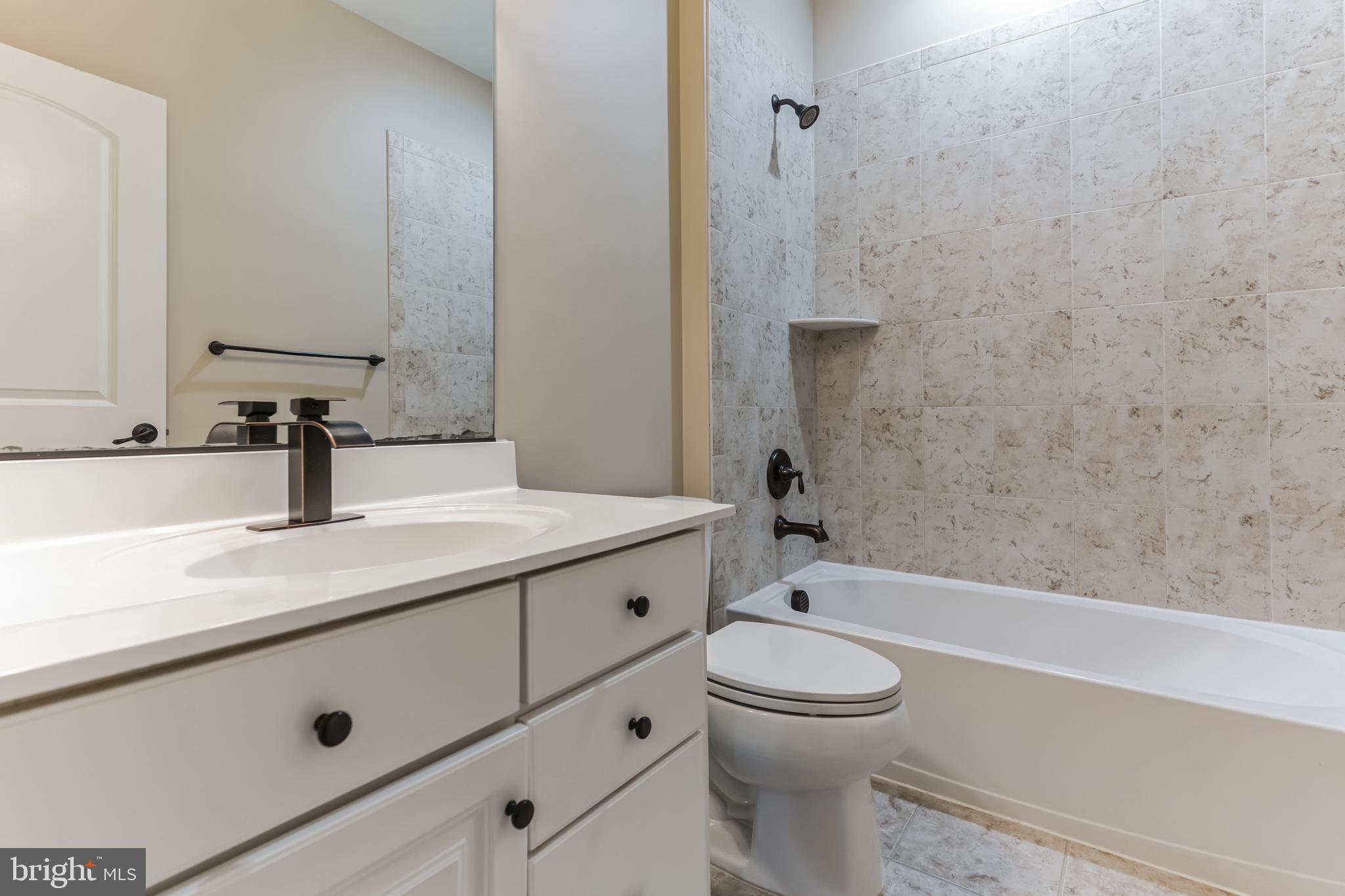 4927 Collingtons Bounty Drive Bowie, MD 20720 - Photo 34 of 38 a bathroom with a sink a toilet and shower