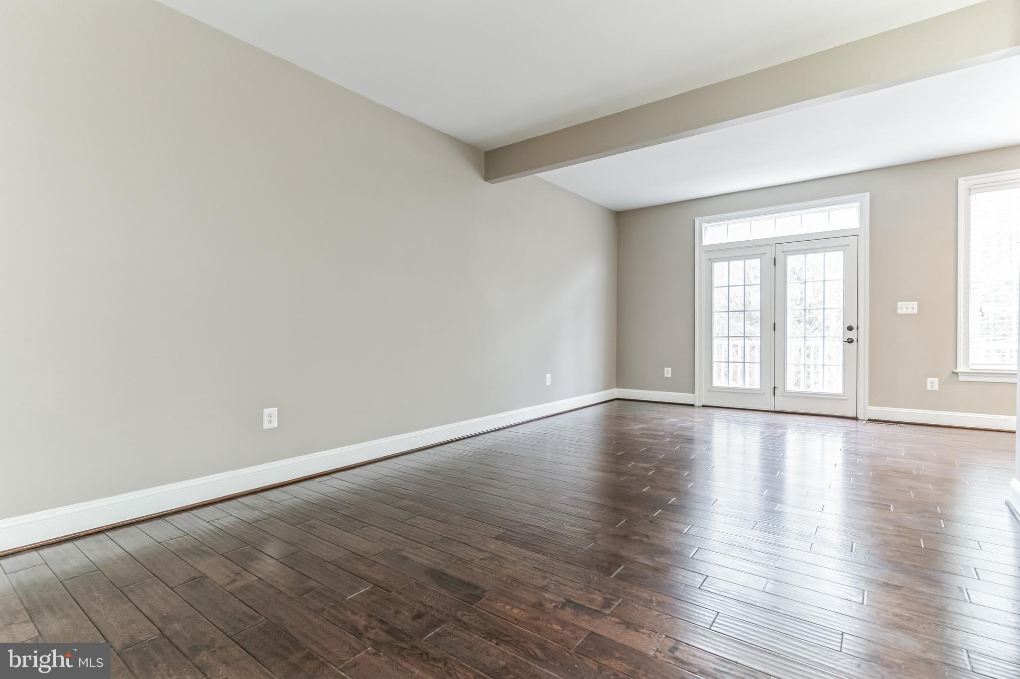 4927 Collingtons Bounty Drive Bowie, MD 20720 - Photo 7 of 38 a view of an empty room with wooden floor and window