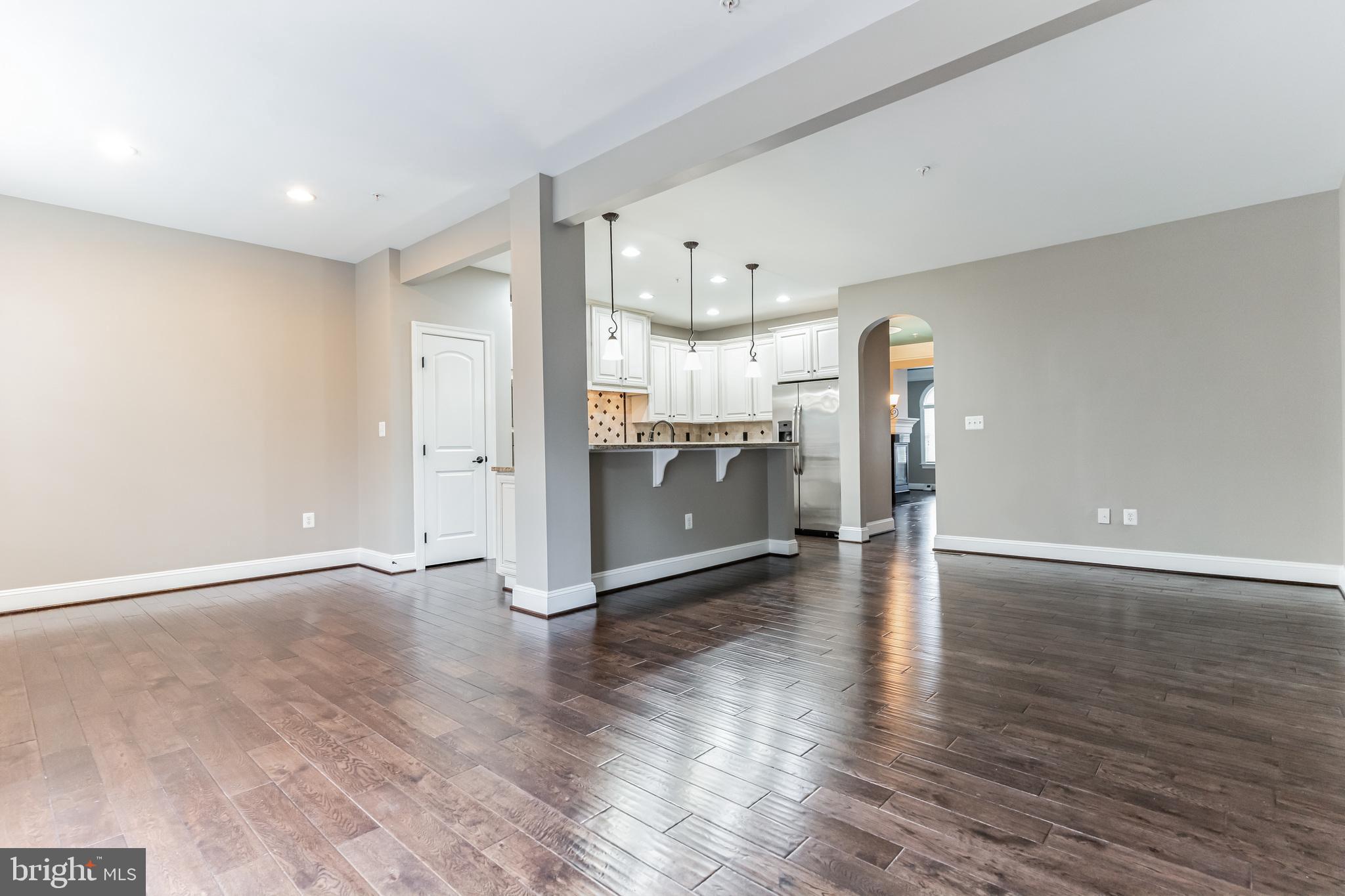 4927 Collingtons Bounty Drive Bowie, MD 20720 - Photo 8 of 38 a view of a kitchen with a fridge and wooden floor