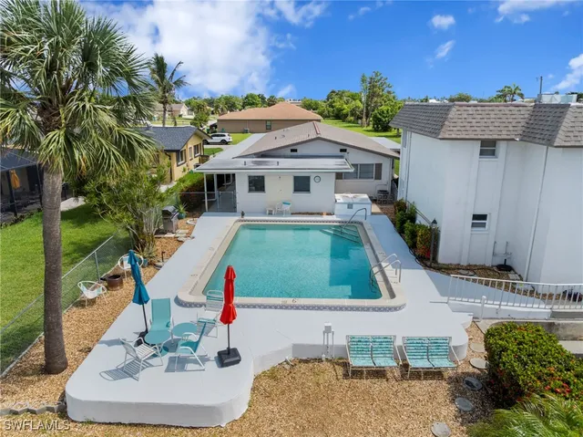 an aerial view of residential houses with outdoor space and parking