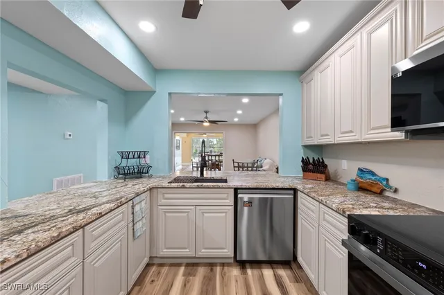 a kitchen with a sink stove and cabinets