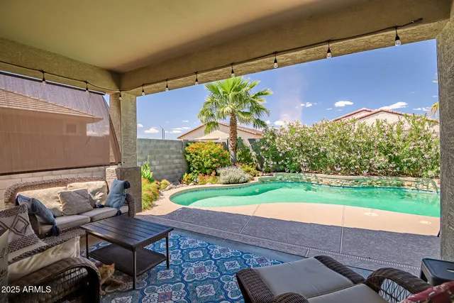 a view of yard from deck with patio