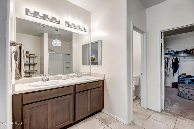 a bathroom with a double vanity sink and a mirror