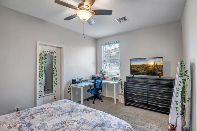 a living room with furniture a flat screen tv and a window