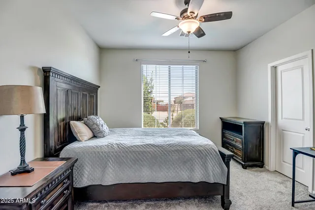 a bedroom with a bed dresser and a window