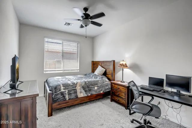 a bedroom with a bed and a desk