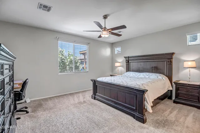 a bedroom with a bed dresser and a window