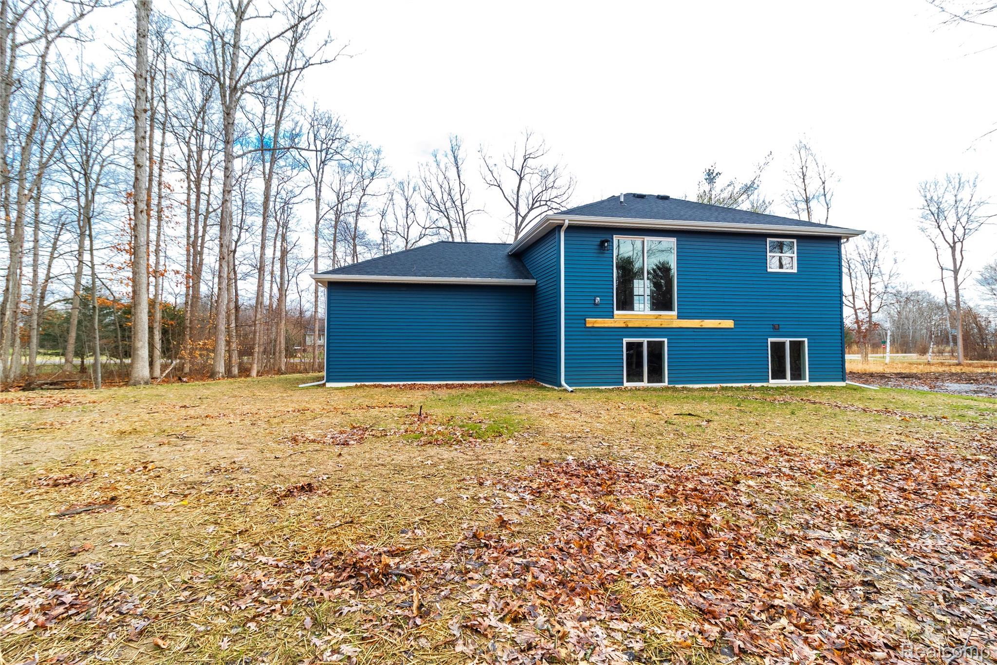 5155 Coldwater Road Lapeer, MI 48446 - Photo 22 of 24 Back of property featuring a lawn