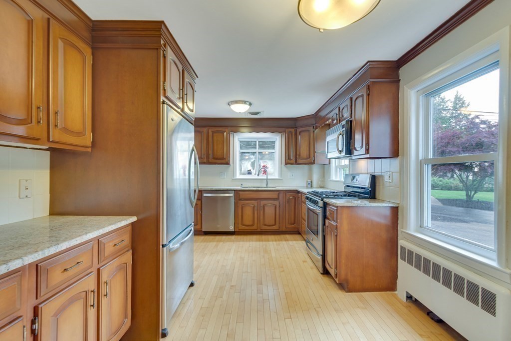 65 Longfellow Road Newton, MA 02462 - Photo 14 of 38 a kitchen with stainless steel appliances granite countertop a stove a sink and a refrigerator