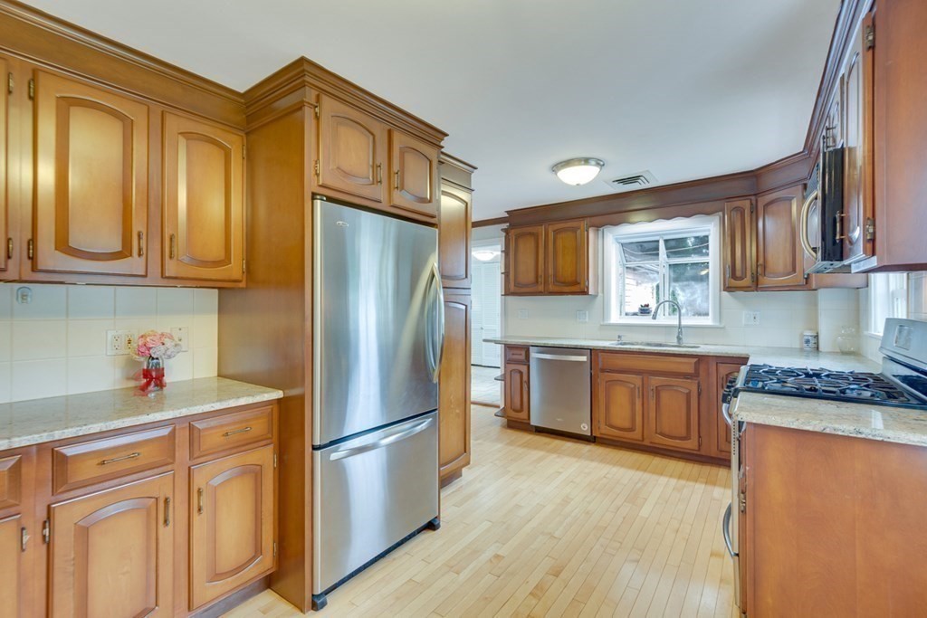 65 Longfellow Road Newton, MA 02462 - Photo 15 of 38 a kitchen with stainless steel appliances granite countertop a refrigerator sink and cabinets