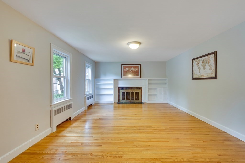 65 Longfellow Road Newton, MA 02462 - Photo 2 of 38 a view of a livingroom with wooden floor and a fireplace