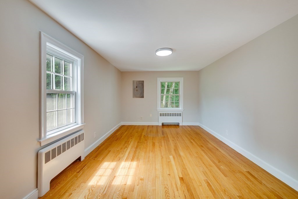 65 Longfellow Road Newton, MA 02462 - Photo 22 of 38 a view of an empty room with wooden floor and a window