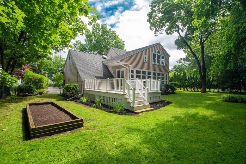 65 Longfellow Road Newton, MA 02462 - Photo 33 of 38 a front view of a house with a yard table and chairs