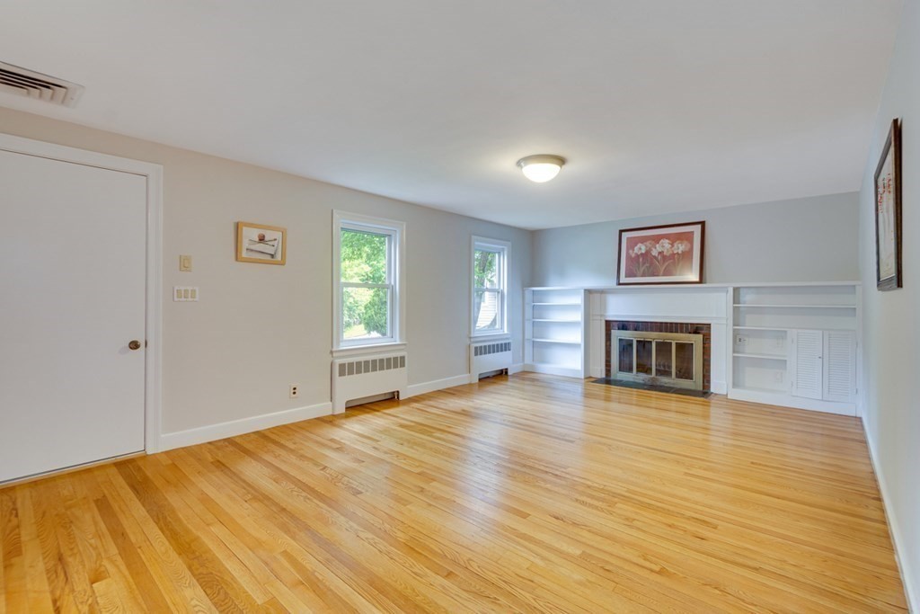 65 Longfellow Road Newton, MA 02462 - Photo 5 of 38 a view of a livingroom with wooden floor and a fireplace