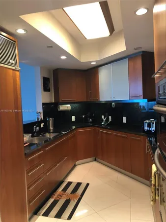 a kitchen with stainless steel appliances granite countertop a sink and cabinets