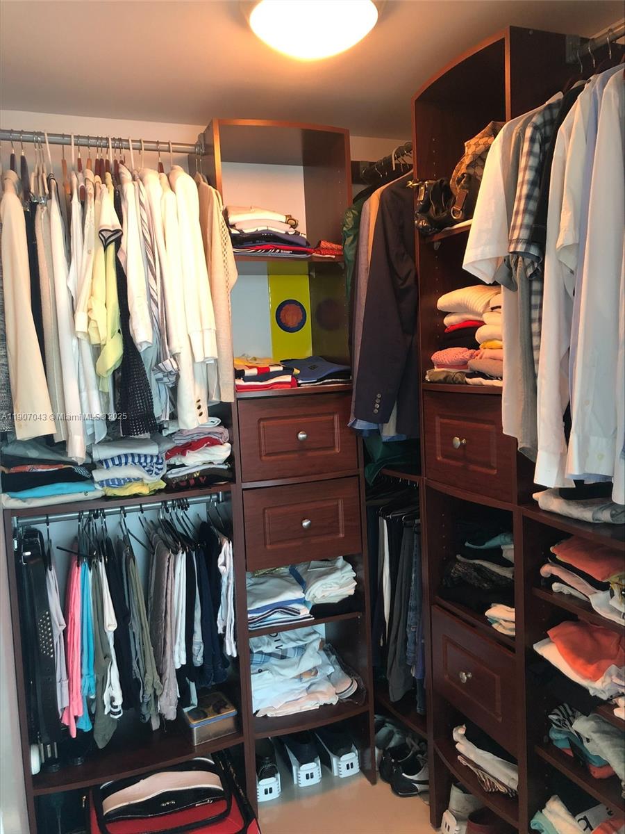 9401 Collins Avenue, Unit 801 Surfside, FL 33154 - Photo 18 of 51 a view of walk in closet with clothes and shoes