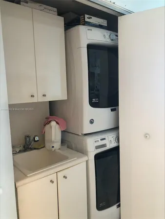 a kitchen with a stove and a white cabinet