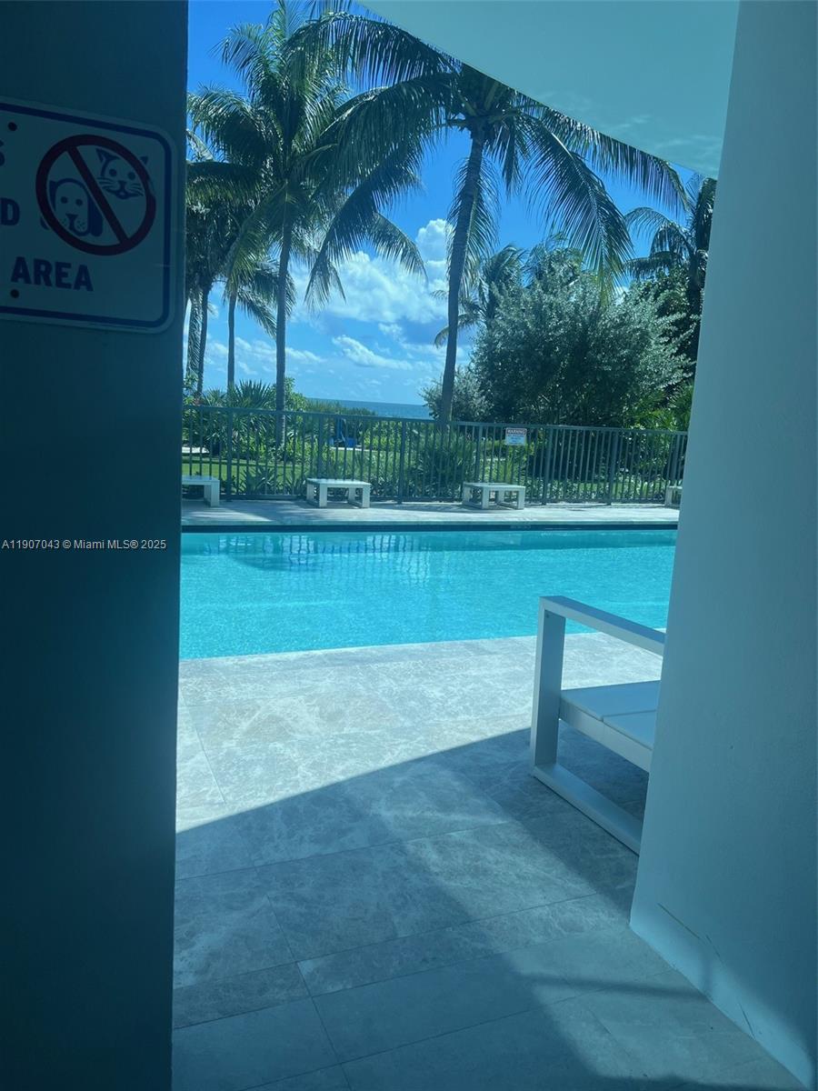 9401 Collins Avenue, Unit 801 Surfside, FL 33154 - Photo 27 of 51 a view of a yard with a bench