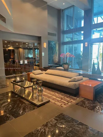 a bedroom with furniture and large window