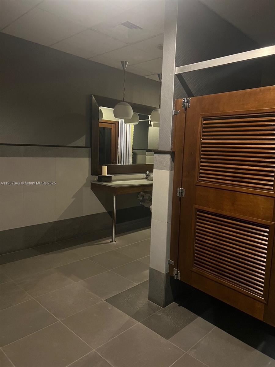 9401 Collins Avenue, Unit 801 Surfside, FL 33154 - Photo 42 of 51 a kitchen with a sink and cabinets